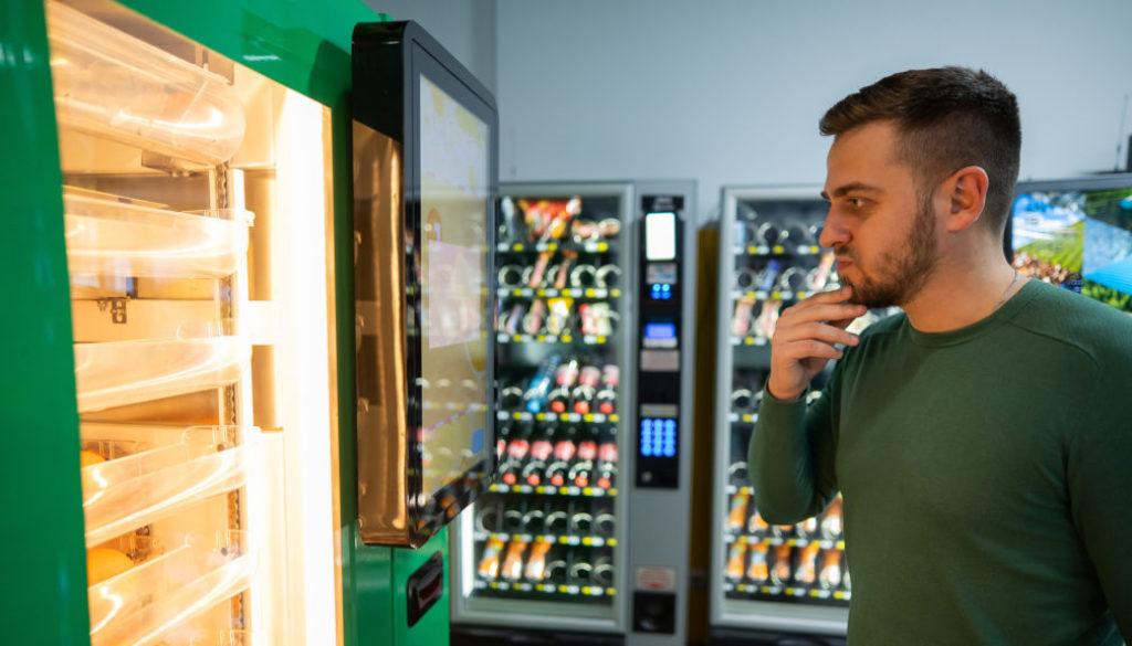 Caucasian Man Buys Freshly Squeezed Orange Juice From Vending Ma